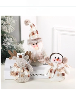 Close-up of plush Christmas ornaments with plaid fabric details and wooden buttons