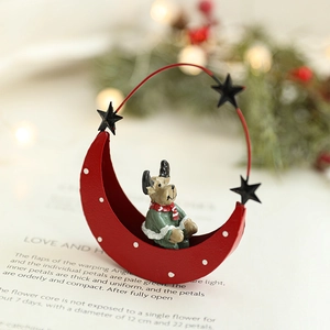 Christmas iron moon pendant with reindeer doll on cozy festive tabletop background