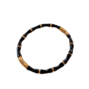 Bracciale stile bambù in acciaio inossidabile con smalto nero e accenti dorati minimalista