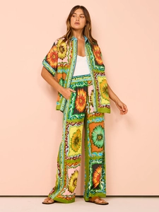 Detail of colorful floral print satin set with short sleeve shirt and wide leg trousers
