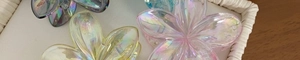 Detail view of colorful plumeria flower hair claws with iridescent pearlescent finish