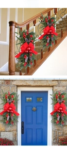Christmas staircase garland detail with red bows, pine cones and LED lights on stairs