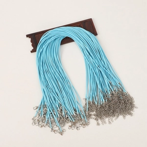 Detail of sky blue necklace cords with metal lobster clasps and extension chains on wood