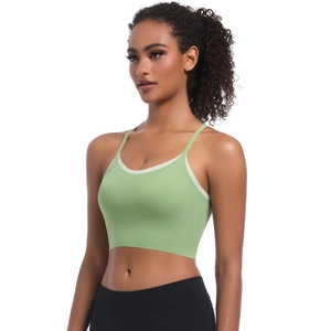 Detail of light green sports bra with white contrast piping and thin shoulder straps