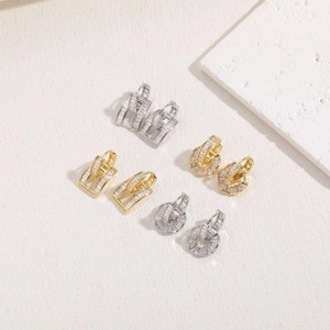 Macro detail of geometric zircon earrings in gold and silver plating with pavé setting