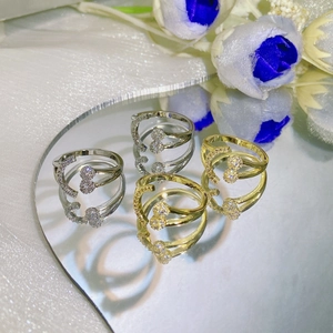 Adjustable silver and gold open rings with moon and circle crystal accents on mirror