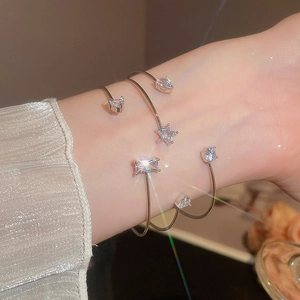 Close-up of sparkling cubic zirconia silver cuff bracelets on a model wrist