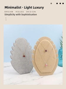 Detailed display of gemstone necklaces on velvet stands featuring gold and silver chains