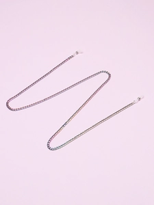 Rainbow metal eyeglass chain with white silicone anti-slip loops on a pink background