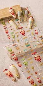Detail showing 5D embossed nail stickers with Chinese red tassels and floral patterns