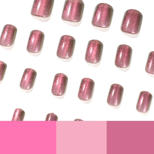 Short pink cat eye press-on nails with glitter finish on clean white background