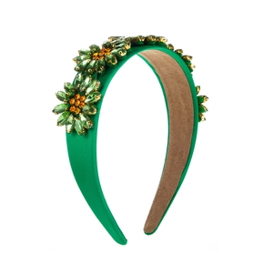 Baroque emerald green satin headband with crystal sunflower jewels on a white background
