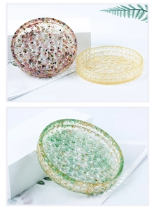 Macro detail of epoxy resin coaster with colorful natural crystal stones and gold foil edges