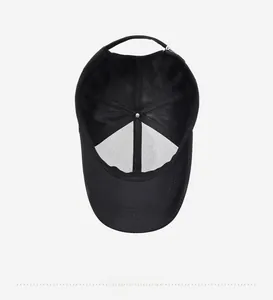 Detailed interior view of a black baseball cap with reinforced stitching and adjustable strap