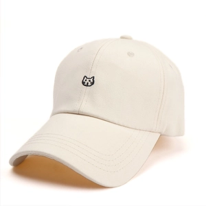 Detail of cute cat embroidery on cream cotton baseball cap with stitched brim