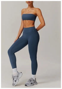 Detail of high-waisted navy yoga leggings and sports bra set on female model