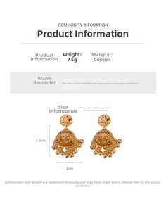 Macro detail of 14K gold plated bell-shaped earrings with intricate hollow design and small beads