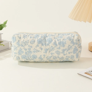 Close-up of quilted cotton pencil case with blue floral pattern and zipper closure