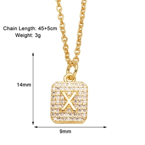 Macro view of gold plated necklace with a rectangular X pendant and zircon stones