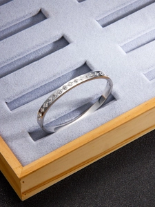 Detailed macro view of silver titanium steel diamond bangle with rhombic texture