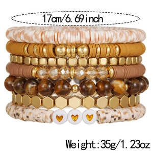 Detailed stack of seven colorful polymer clay bead bracelets with a heart charm detail