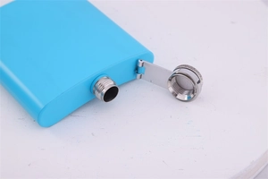 Close-up of a blue metal hip flask showing the silver hinged cap and threaded opening