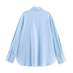 Sky blue long sleeve linen shirt for women featuring buttoned cuffs and a curved back hem