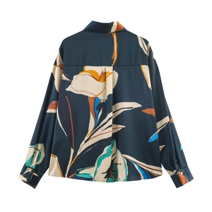 Back view of women's long-sleeve floral shirt in dark green with abstract print