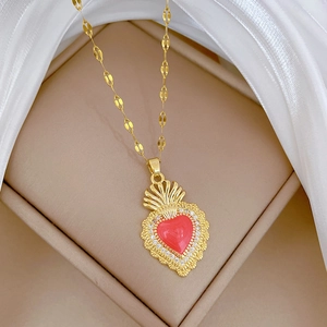 Vintage gold sacred heart necklace with red heart pendant and dazzling crystals on silk