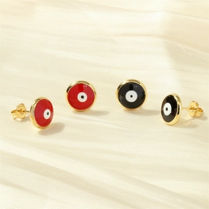 Detailed close-up of 18K gold-plated Evil Eye stud earrings in red and black enamel