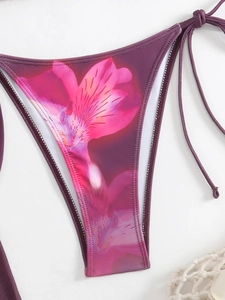 Detail view of purple floral bikini bottom with side ties and high-quality stitching