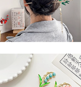 Detail of traditional Chinese floral hair pin with metal tassels and colorful enamel finish