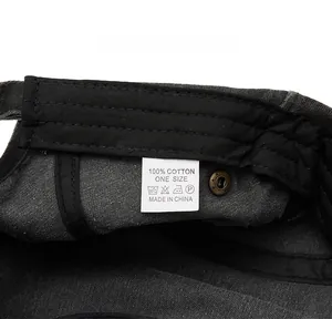 Macro detail of washing label showing 100% cotton fabric and sizing on the gray beret hat