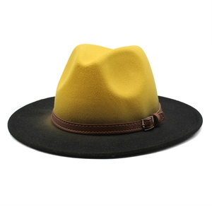 Detail view of yellow-black gradient wool fedora hat with brown leather buckle band