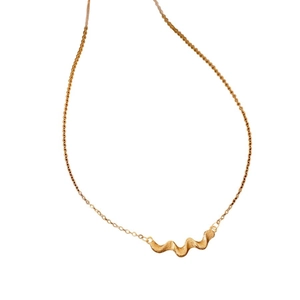 Vintage brushed gold necklace with wavy pendant on elegant thin chain over white background