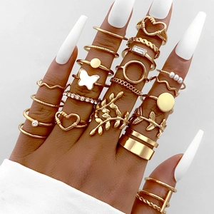 21-piece gold ring set featuring heart butterfly and leaf designs with pearls