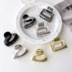 Elegant metal hair claw clip set with heart and geometric designs in gold silver and black