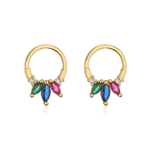 Macro detail of gold round earrings featuring colorful cubic zirconia in claw settings