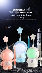 Three astronaut LED desk lamps with pencil holders in pink, blue, and white colors