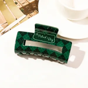 Macro detail of St. Patrick's Day green plaid hair claw clip with gold lettering