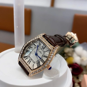 Detailed macro view of the tonneau white dial and rose gold case of this lady watch