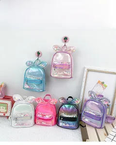 Detail of colorful mini backpacks with bow ties and sequins in various vibrant colors