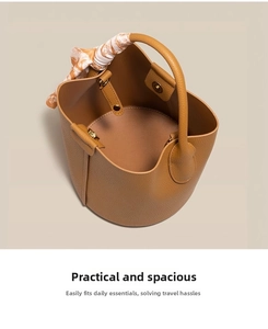 Detail of caramel lychee grain leather bucket bag with decorative silk scarf on handle