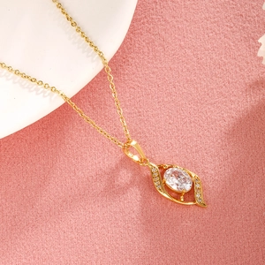 Macro shot of gold-plated copper pendant with large oval clear cubic zirconia