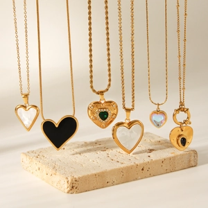 Collection of six elegant gold heart pendant necklaces featuring pearl and gemstone accents