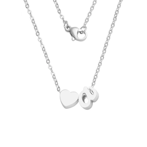 Close-up of polished stainless steel heart and letter pendant on a cross chain necklace