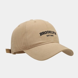 Detailed close-up of Brooklyn embroidery on khaki cotton canvas baseball cap