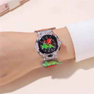 Close-up of kids dinosaur quartz watch with green triceratops dial and gray silicone strap