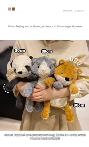 Close-up of 30cm plush panda and fox toys held by a model in a warm home setting