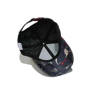 Detail view of denim baseball cap interior showing 100% polyester label and metal buckle